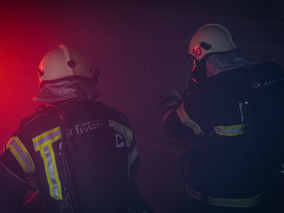 Two emergency rescue professionals on a red background, symbolizing National Preparedness Month