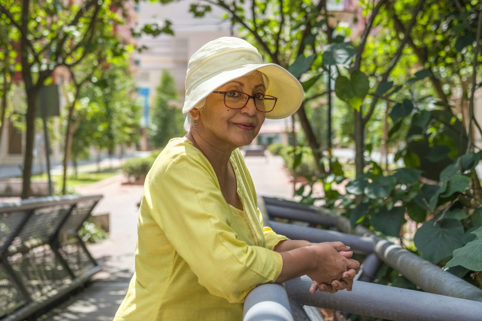 A woman in a sunhat and shade in order to demonstrate the importance of UV safety