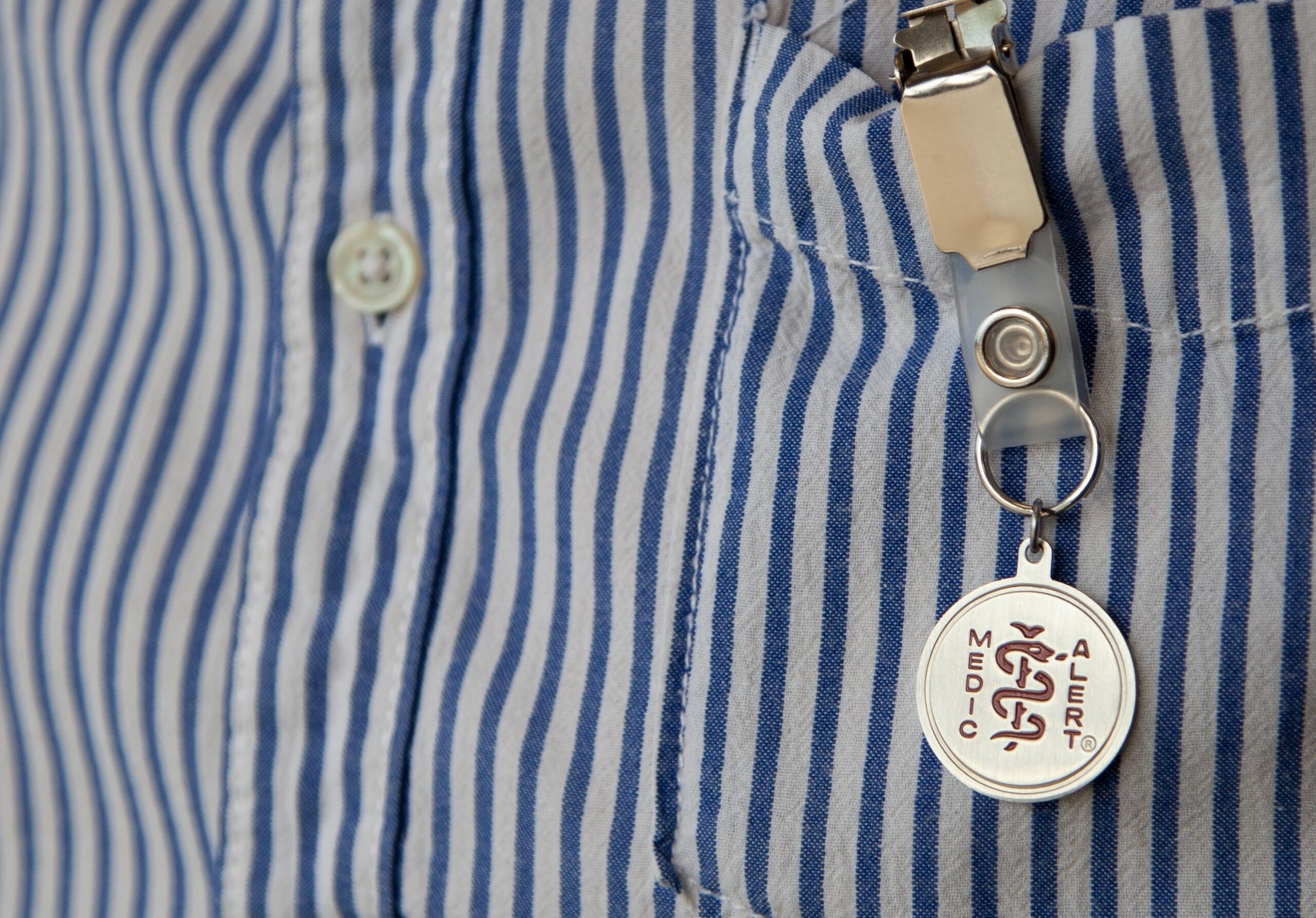 A MedicAlert badge on someone's pocket to open the discussion for Electronic Caregiver
