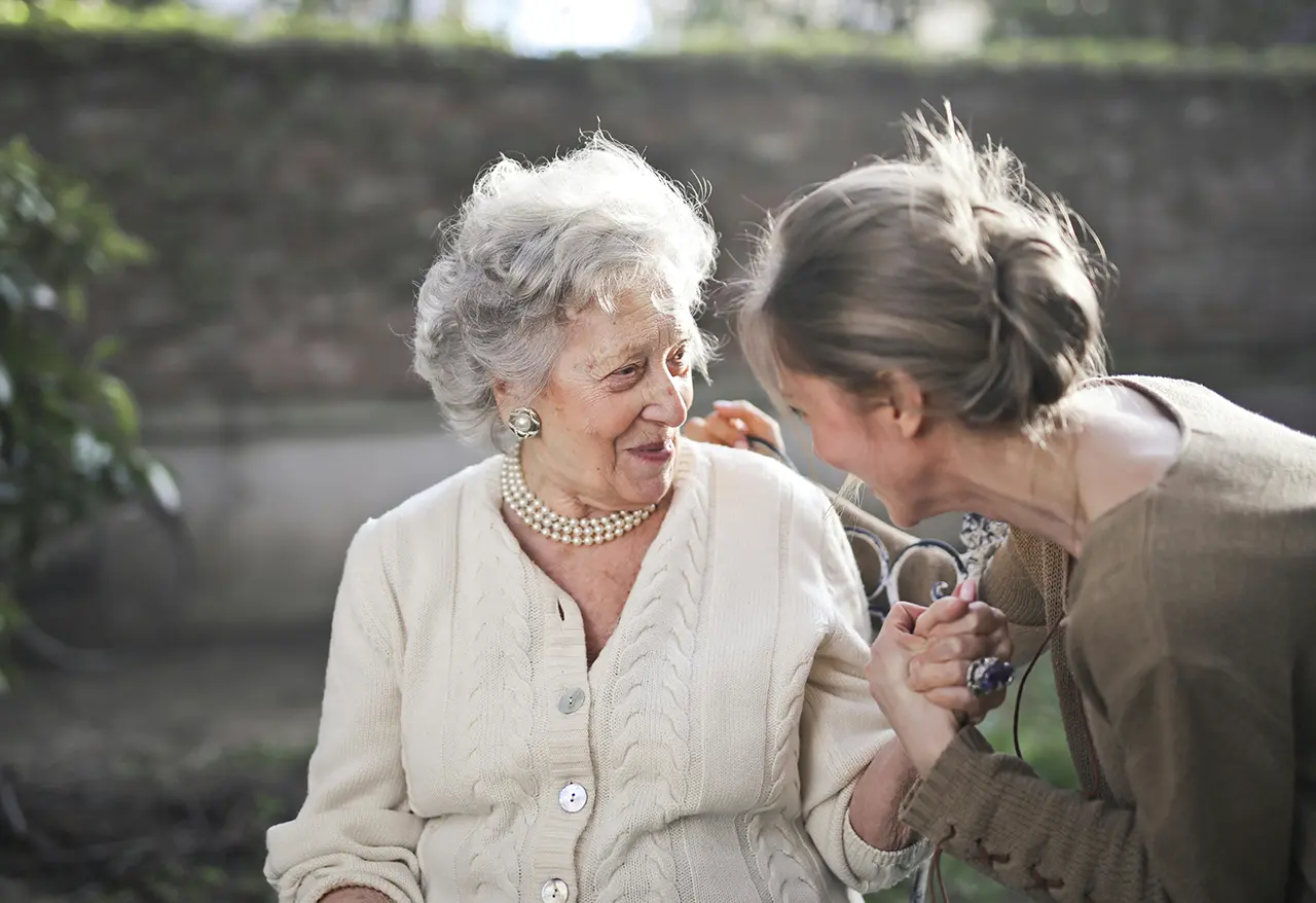 elderly woman with dementia being cared for by younger woman