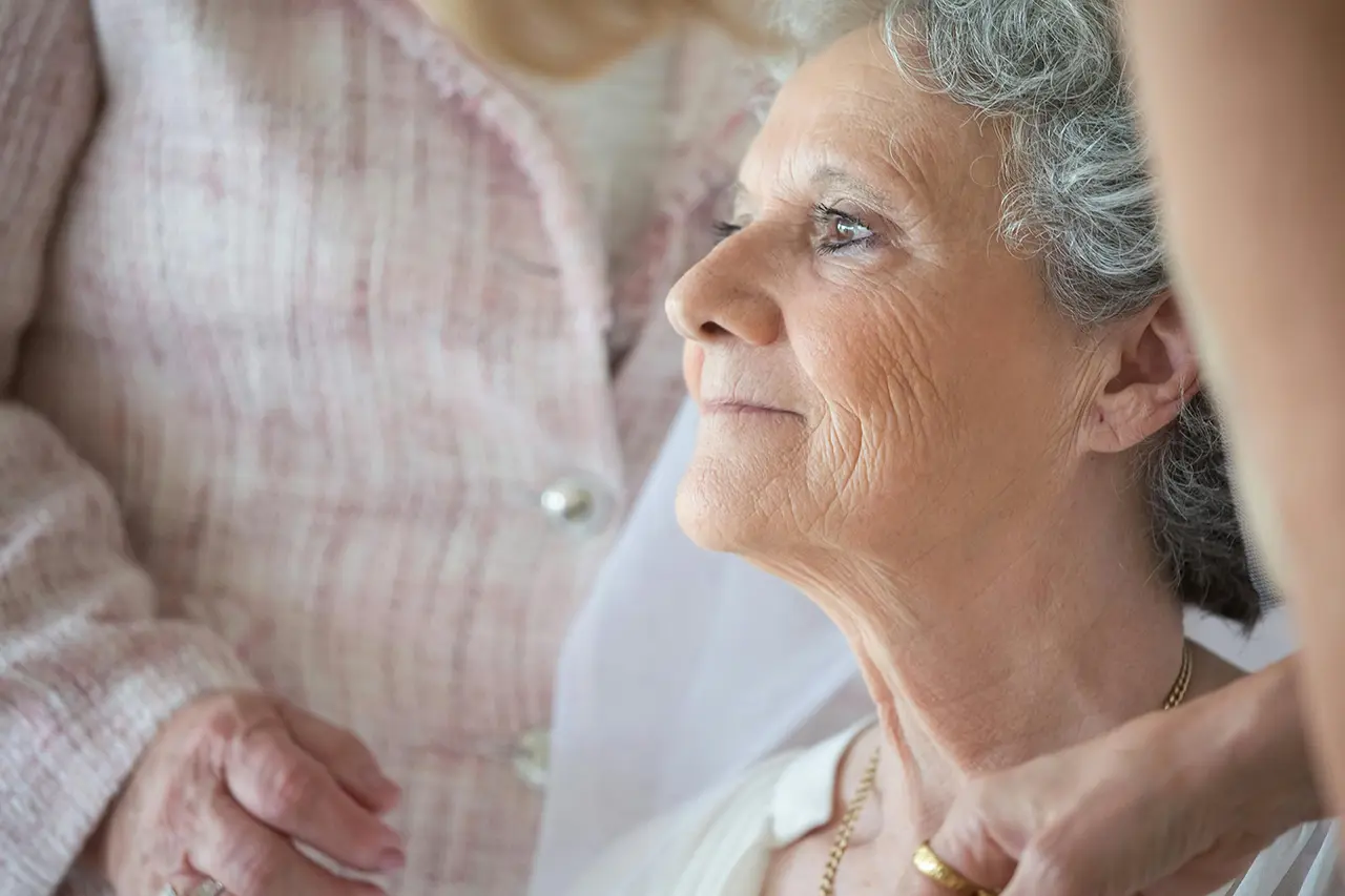 elderly woman at home with caregivers