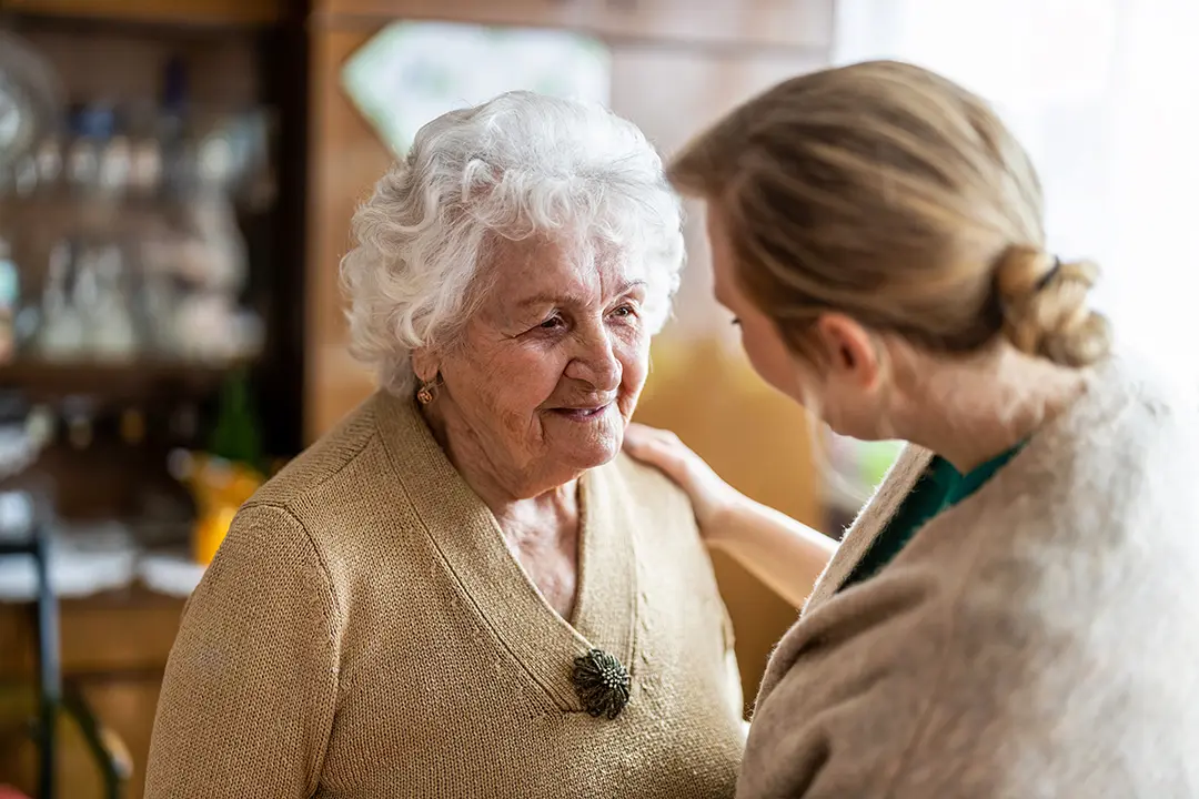 senior care specialist assisting an elderly woman in Syracuse, NY